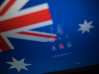 Social network logos display on a smartphone screen and the Australian flag appears on a computer screen in this photo illustration in Athen...