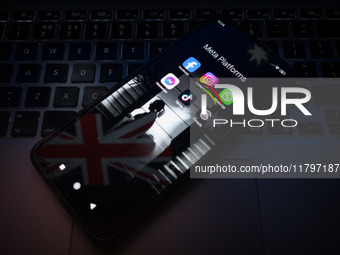 Social network logos display on a smartphone screen and the Australian flag appears on a computer screen in this photo illustration in Athen...