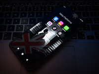 Social network logos display on a smartphone screen and the Australian flag appears on a computer screen in this photo illustration in Athen...