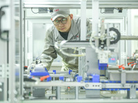 A worker produces automatic instrument valve products at a production workshop of an intelligent automatic control system company in Huzhou,...