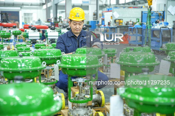 A worker produces automatic instrument valve products at a production workshop of an intelligent automatic control system company in Huzhou,...