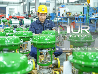 A worker produces automatic instrument valve products at a production workshop of an intelligent automatic control system company in Huzhou,...