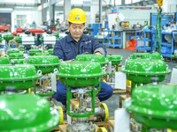 A worker produces automatic instrument valve products at a production workshop of an intelligent automatic control system company in Huzhou,...