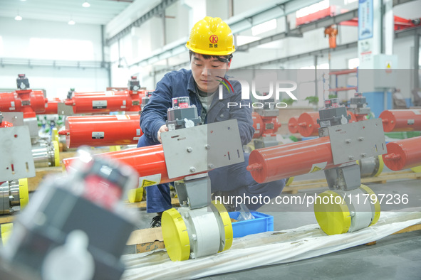 A worker produces automatic instrument valve products at a production workshop of an intelligent automatic control system company in Huzhou,...