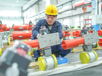 A worker produces automatic instrument valve products at a production workshop of an intelligent automatic control system company in Huzhou,...