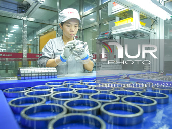 A worker produces automatic instrument valve products at a production workshop of an intelligent automatic control system company in Huzhou,...