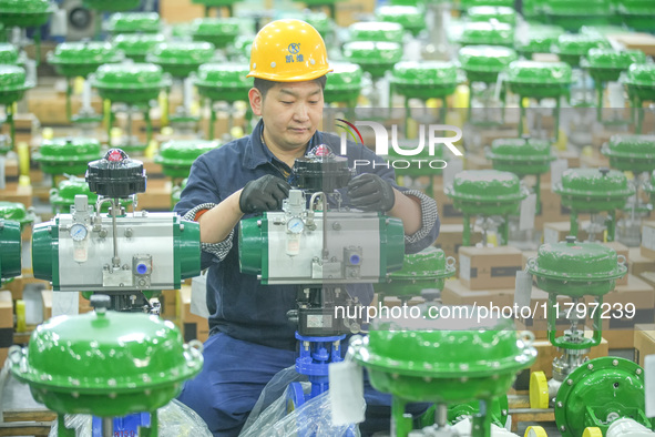 A worker produces automatic instrument valve products at a production workshop of an intelligent automatic control system company in Huzhou,...