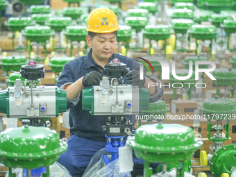 A worker produces automatic instrument valve products at a production workshop of an intelligent automatic control system company in Huzhou,...