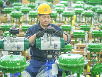 A worker produces automatic instrument valve products at a production workshop of an intelligent automatic control system company in Huzhou,...