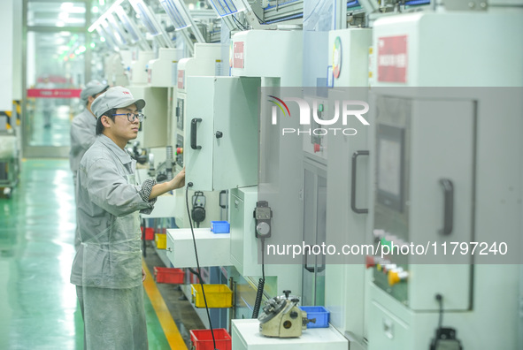 A worker produces automatic instrument valve products at a production workshop of an intelligent automatic control system company in Huzhou,...