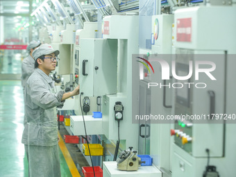 A worker produces automatic instrument valve products at a production workshop of an intelligent automatic control system company in Huzhou,...