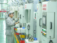 A worker produces automatic instrument valve products at a production workshop of an intelligent automatic control system company in Huzhou,...