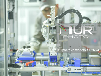 A worker produces automatic instrument valve products at a production workshop of an intelligent automatic control system company in Huzhou,...