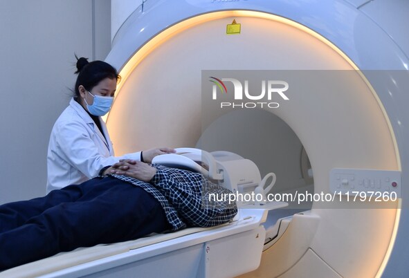 A medical worker performs an MRI exam on a patient in Handan, Hebei province, China, on January 1, 2022. 