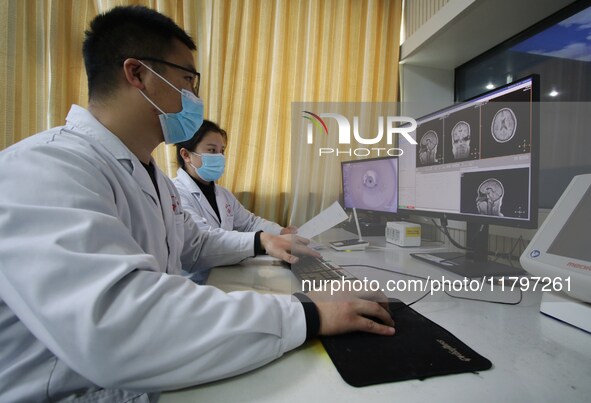 A medical worker examines an MRI image in Handan, Hebei province, China, on January 1, 2022. 