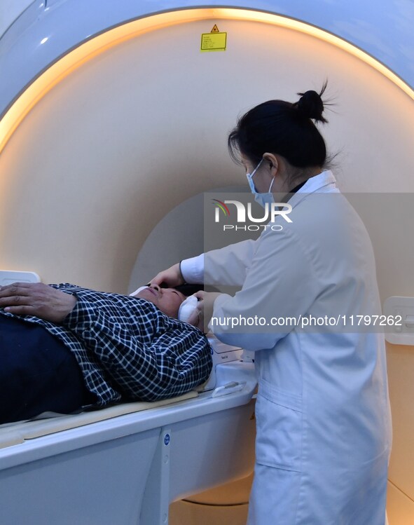 A medical worker performs an MRI exam on a patient in Handan, Hebei province, China, on January 1, 2022. 