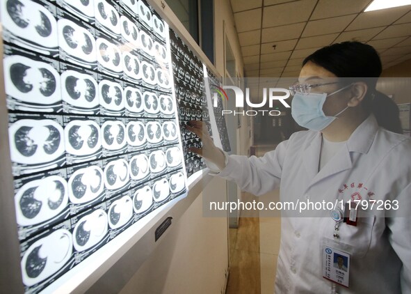 A doctor examines a CT image in Handan, Hebei province, China, on January 1, 2022. 