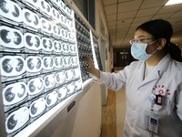 A doctor examines a CT image in Handan, Hebei province, China, on January 1, 2022. (