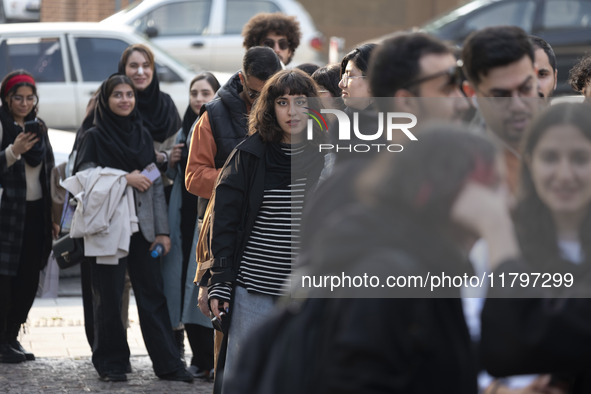 A young Iranian woman stands in line outside the Museum of Contemporary Arts while waiting to visit the ''Eye to Eye, Portraiture in Modern...