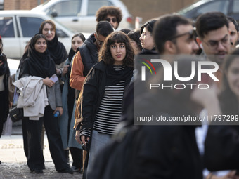 A young Iranian woman stands in line outside the Museum of Contemporary Arts while waiting to visit the ''Eye to Eye, Portraiture in Modern...