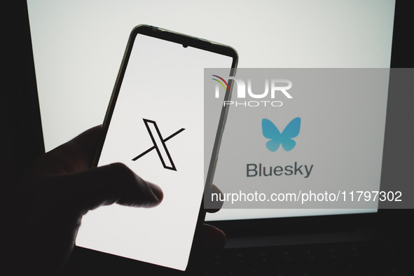 The X (former Twitter) logo appears on a smartphone screen, and a Bluesky logo appears on a computer screen in this photo illustration in At...