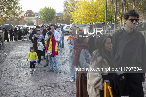 Iranian people stand in line outside the Museum of Contemporary Arts while waiting to visit the ''Eye to Eye, Portraiture in Modern and Cont...