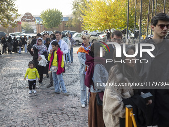 Iranian people stand in line outside the Museum of Contemporary Arts while waiting to visit the ''Eye to Eye, Portraiture in Modern and Cont...