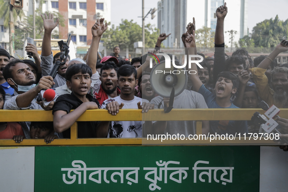 Automatic three-wheel drivers shout slogans as they block the roads and railway track after the high court orders the termination of three-w...