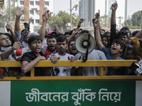 Automatic three-wheel drivers shout slogans as they block the roads and railway track after the high court orders the termination of three-w...