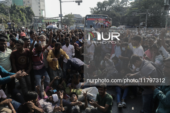 Automatic three-wheel drivers shout slogans as they block the roads and railway track after the high court orders the termination of three-w...