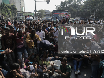 Automatic three-wheel drivers shout slogans as they block the roads and railway track after the high court orders the termination of three-w...