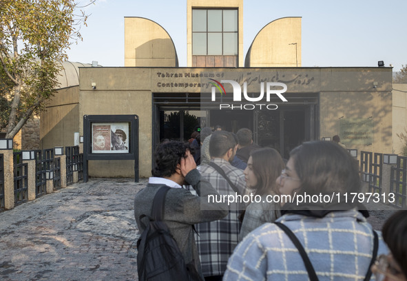 Young Iranian people stand in line outside the Museum of Contemporary Arts while waiting to visit the ''Eye to Eye, Portraiture in Modern an...