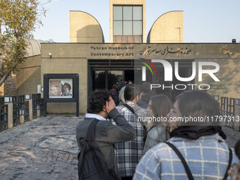 Young Iranian people stand in line outside the Museum of Contemporary Arts while waiting to visit the ''Eye to Eye, Portraiture in Modern an...