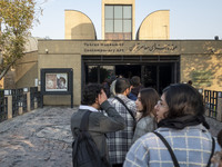 Young Iranian people stand in line outside the Museum of Contemporary Arts while waiting to visit the ''Eye to Eye, Portraiture in Modern an...