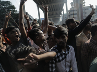 Automatic three-wheel drivers shout slogans as they block the roads and railway track after the high court orders the termination of three-w...