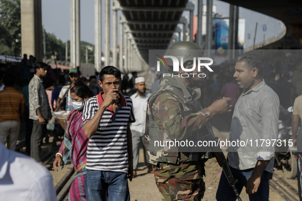 Commuters walk past a blocked rail track during a protest by Automatic Three Wheel Drivers in Dhaka, Bangladesh, on November 21, 2024. 