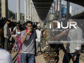 Commuters walk past a blocked rail track during a protest by Automatic Three Wheel Drivers in Dhaka, Bangladesh, on November 21, 2024. (