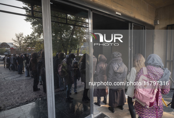 Young Iranian women stand in line outside the Museum of Contemporary Arts while waiting to visit the ''Eye to Eye, Portraiture in Modern and...