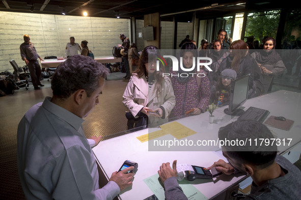 A young Iranian woman waits to receive a ticket to visit the ''Eye to Eye: Portraiture in Modern and Contemporary Art'' exhibition at the Mu...