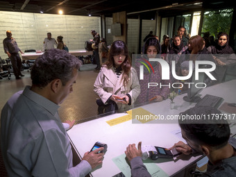 A young Iranian woman waits to receive a ticket to visit the ''Eye to Eye: Portraiture in Modern and Contemporary Art'' exhibition at the Mu...