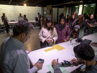 A young Iranian woman waits to receive a ticket to visit the ''Eye to Eye: Portraiture in Modern and Contemporary Art'' exhibition at the Mu...