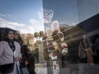 Iranian women walk past ''Cherche Aubaine'' from the series ''Deputation'' by Jean Dubuffet, the French painter and sculptor, while visiting...