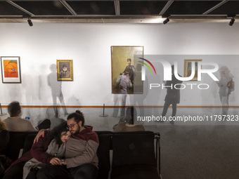 A young Iranian couple rests while people explore the ''Eye to Eye: Portraiture in Modern and Contemporary Art'' exhibition at the Museum of...