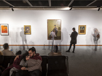 A young Iranian couple rests while people explore the ''Eye to Eye: Portraiture in Modern and Contemporary Art'' exhibition at the Museum of...