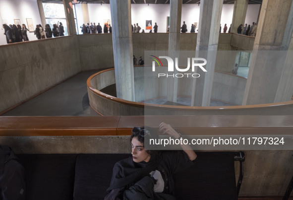 A young Iranian woman rests while people explore the ''Eye to Eye, Portraiture in Modern and Contemporary Art'' exhibition at the Museum of...