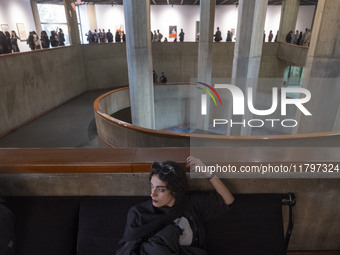 A young Iranian woman rests while people explore the ''Eye to Eye, Portraiture in Modern and Contemporary Art'' exhibition at the Museum of...