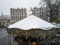 The view from Montmartre shows heavy snowfall as Paris is under the second highest weather warning by the French national weather service fo...