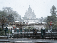 A view of the Basilique du Sacre-Coeur in heavy snowfall as Paris is under the second highest weather warning by the French national weather...