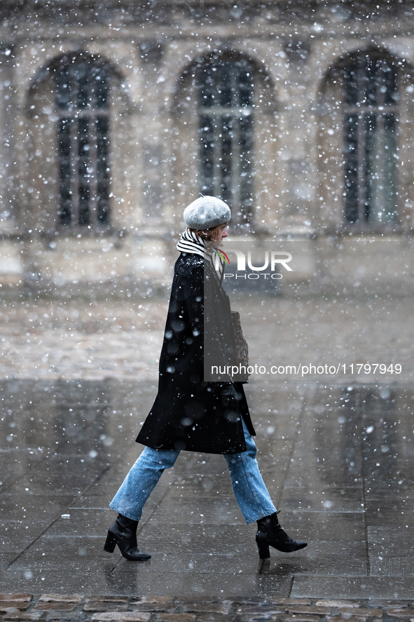 A woman walks in the courtyard of the Louvre Museum in heavy snowfall as Paris is under the second highest weather warning by the French nat...