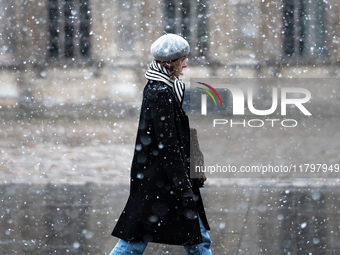 A woman walks in the courtyard of the Louvre Museum in heavy snowfall as Paris is under the second highest weather warning by the French nat...